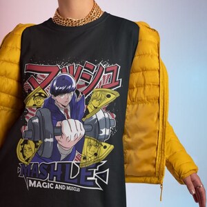 May include: Black t-shirt with a graphic print of an anime character lifting weights. The text "MASHLE MAGIC AND MUSCLES" is printed on the shirt.