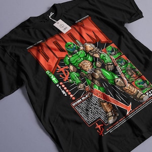 May include: Black t-shirt featuring a green and brown illustration of a character with a sword, with the word "DOOM" in red block letters. The shirt also has Japanese text and the words "DOOM SLAY".