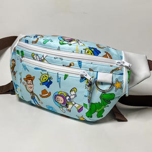 Toy themed fanny pack / waist bag with three zippered pockets