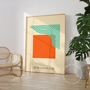 May include: A minimalist poster with a geometric design in orange, green, and white. The poster has the word "BAUHHAUS" printed at the bottom.