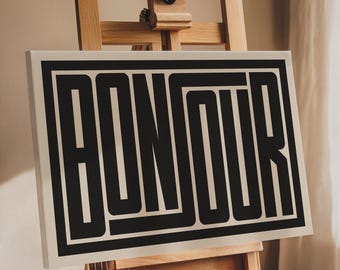 May include: A canvas print with the word "BONJOUR" in black block letters on a cream background. The print is displayed on an easel.