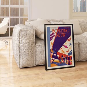 Boarding Now Airplane in a black frame above a sofa in a living room