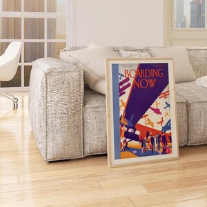 Boarding Now Airplane in a natural oak frame above a sofa in a living room