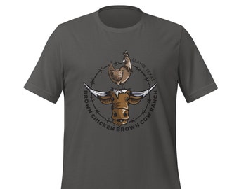 May include: Dark gray t-shirt featuring a graphic of a brown longhorn cow, a chicken, and the text "Brown Chicken Brown Cow Ranch Llano Texas" in a circular design. The design is in shades of brown, tan, and white.