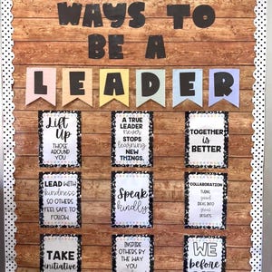 May include: A bulletin board with a wood-grain background and a white polka-dot border. The words "WAYS TO BE A LEADER" are at the top. Below are colorful banners spelling "LEADER" and inspirational quotes.