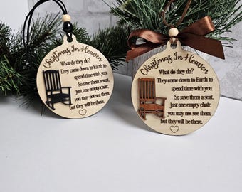 May include: Two wooden Christmas ornaments with a rocking chair design and the text "Christmas In Heaven. What do they do? They come down to Earth to spend time with you. So save them a seat, just one empty chair. You may not see them, but they will be there."