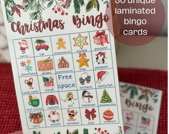 May include: A set of Christmas Bingo cards with festive illustrations of Santa, ornaments, and other holiday symbols. The cards are laminated and feature the text "Christmas Bingo" and "30 unique laminated bingo cards."