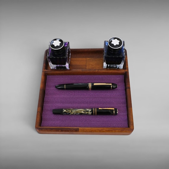 A solid wood pen tray built specifically for fountain pen collectors, with a dedicated ink compartment — genuinely thoughtful craft for a niche obsession.