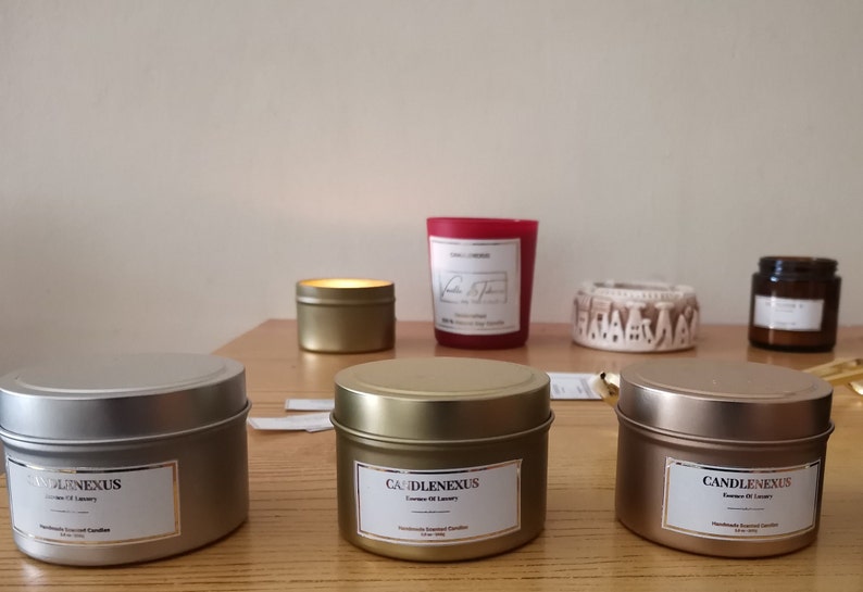 Scented Soy Candles in various tins. Luxury gold foil labels as well among with wood wick