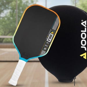May include: A black pickleball paddle with a white grip and a black protective case. The paddle has a gradient edge of yellow, orange, and blue. The paddle and case have the brand name "JOOLA".