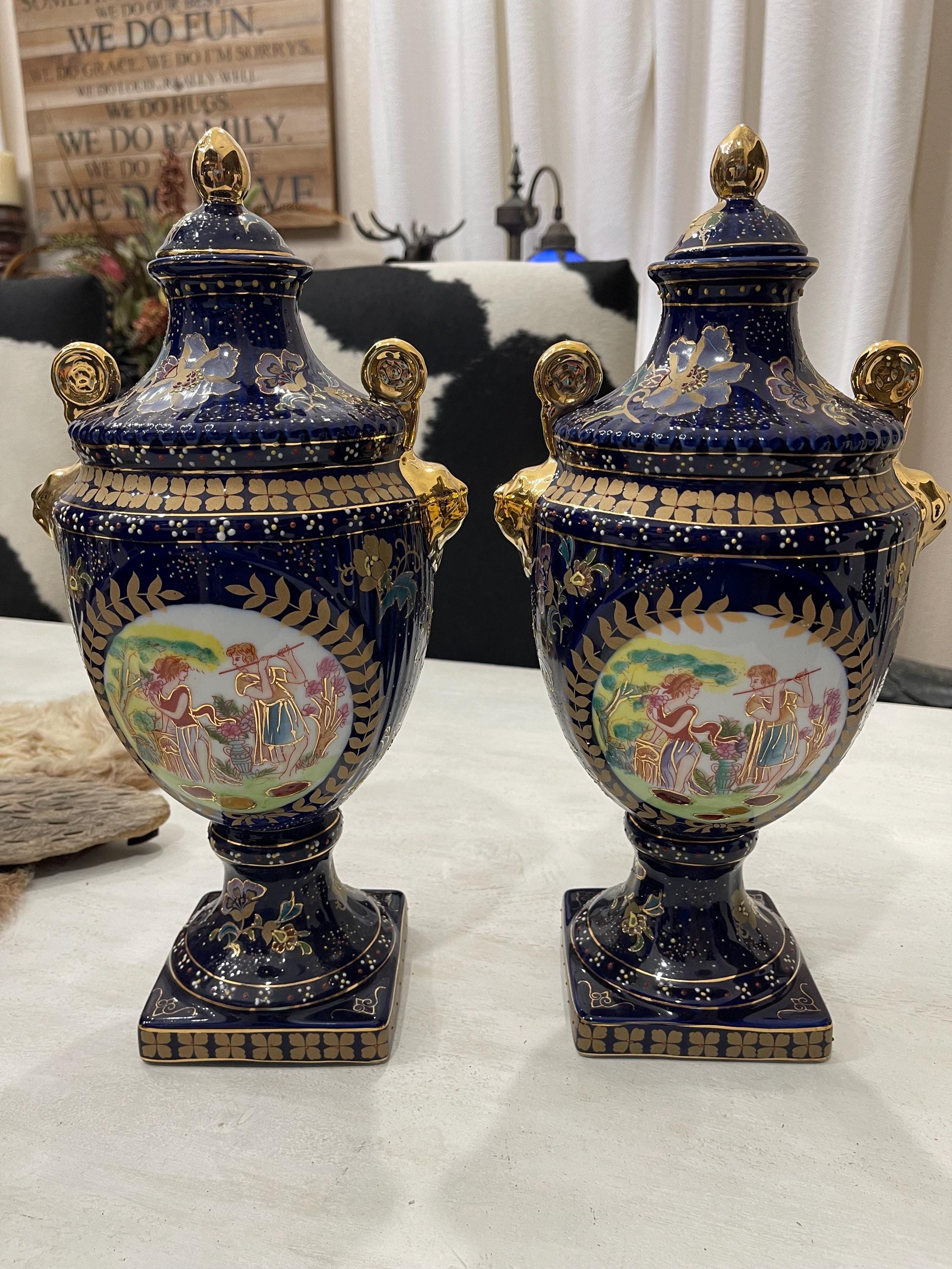A pair of hand painted Sevres style porcelain urns