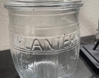 Vintage clear glass barrel Planters running Mr. Peanut cookie jar canister with lid.
