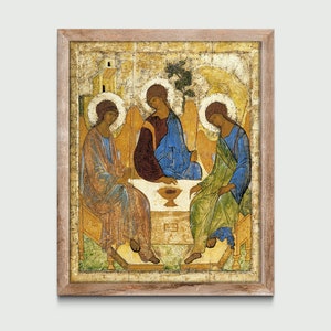 May include: A framed painting depicting the Holy Trinity, three figures in a golden halo, seated on a throne with a chalice in the center. The figures are painted in a traditional Byzantine style with gold backgrounds and intricate details.