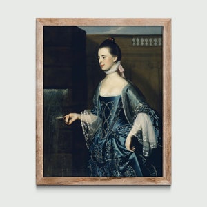 Puede incluir: Una pintura al óleo enmarcada de una mujer con un vestido azul con cuello y mangas de encaje blanco. Ella está de pie en una habitación con una fuente en el fondo.