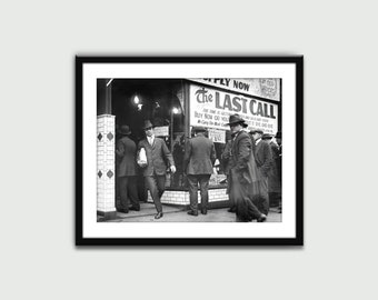 May include: Black and white photo of a group of men standing in front of a store with a sign that reads "The Last Call" and "Buy Now Or You Will Land Die".