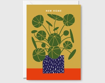 May include: A new home greeting card with a green plant in a blue and white patterned pot on a yellow and orange background. The card says "New Home" at the top.