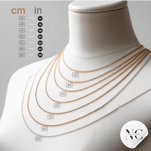 a white mannequin with a number of necklaces on it