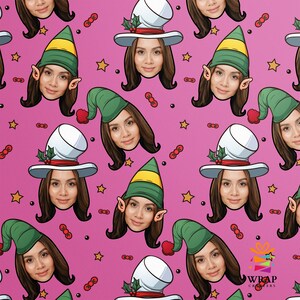 May include: Pink wrapping paper with a repeating pattern of elf and Santa hats with faces. The hats are green, white, and red with gold stars and red berries scattered throughout the background. The text "WRAP CRAFTER" is in the bottom right corner.