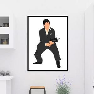 May include: A framed art print featuring a minimalist illustration of a man in a black suit holding a gun. The artwork has a white background and a black frame, suitable for home decor.