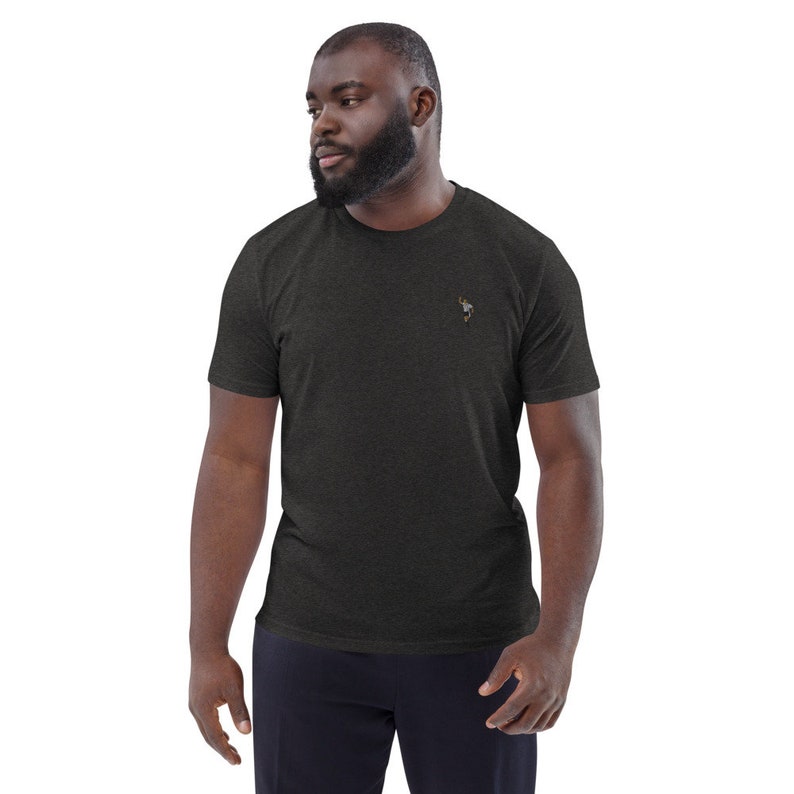 May include: A dark heather grey t-shirt with a small embroidered design on the left chest.