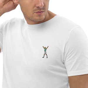 May include: White t-shirt with a green and white soccer player graphic.