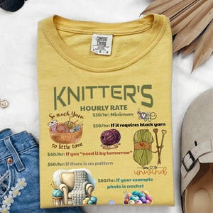 May include: A yellow t-shirt with a humorous graphic about knitter's hourly rates. The graphic features yarn, needles, and a chair with a blanket. The text reads "KNITTER'S HOURLY RATE So much yarn So little time $20/hr: Minimum $30/hr: If it requires black yarn $40/hr: If you "need it by tomorrow" $50/hr: If there is no pattern $80/hr: If your example photo is crochet"