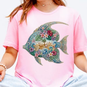 A vibrant digital design of a tropical fish decorated with a faux rhinestone and gemstone texture. The fish features a miniature tropical beach scene with a palm tree, beach chair, and waves, accented by pink hibiscus flowers. Intended for crafts, sublimation and DTF printing.