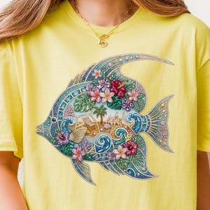 A vibrant digital design of a tropical fish decorated with a faux rhinestone and gemstone texture. The fish features a miniature tropical beach scene with a palm tree, beach chair, and waves, accented by pink hibiscus flowers. Intended for crafts, sublimation and DTF printing.