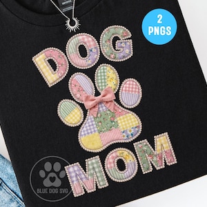 May include: Black t-shirt featuring the text "DOG MOM" in a patchwork style. The "O" in DOG is a paw print with a pink bow. The letters and paw print are made of various floral and gingham fabrics.