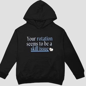 May include: Black hooded sweatshirt with the text "Your rotation seems to be a skill issue" and a small white sheep graphic.