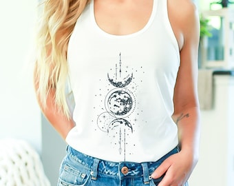 May include: White tank top with a black and white graphic of three moons and stars. The graphic is centered on the front of the tank top.