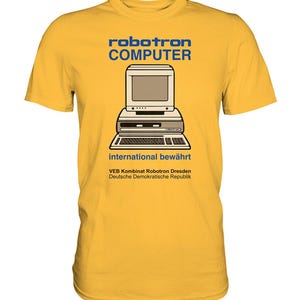 Könnte beinhalten: Gelbes T-Shirt mit einer Vintage-Computergrafik und dem Text "robotron COMPUTER international bewährt VEB Kombinat Robotron Dresden Deutsche Demokratische Republik".