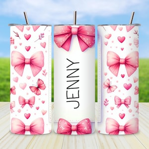 May include: A white tumbler with a pink bow and butterfly pattern. The tumbler has the name "JENNY" printed in black. The design includes pink hearts and bows. A silver straw is inserted in the lid.