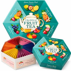 May include: A hexagonal box of FinesTea fruit tea featuring a teapot illustration and text reading a big selection of FRUIT TEA. The box displays various fruit graphics including lemon, passion fruit, orange, ginger, berries, guava, mango, and peach. An open box reveals colorful tea bags arranged in a circular pattern.