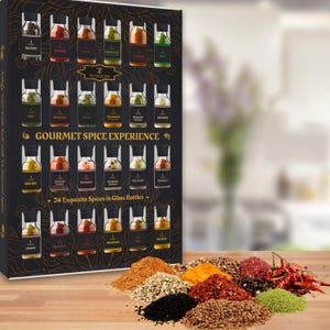 May include: A gourmet spice collection gift set with 24 exquisite spices in glass bottles. The black box has gold accents and the text "GOURMET SPICE EXPERIENCE". A variety of colourful spices are arranged on a wooden surface.