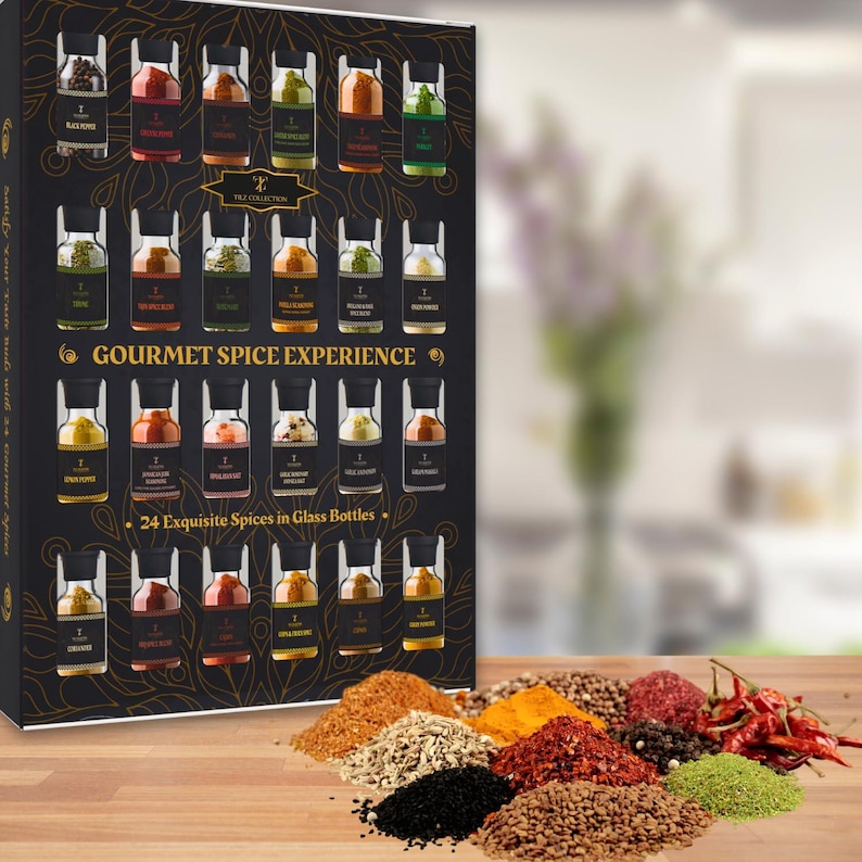 May include: A gourmet spice collection gift set with 24 exquisite spices in glass bottles. The black box has gold accents and the text "GOURMET SPICE EXPERIENCE". A variety of colourful spices are arranged on a wooden surface.