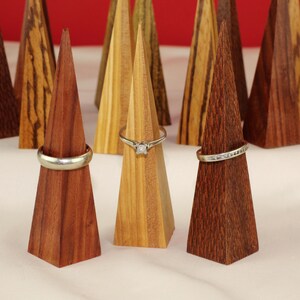 Modern Ring Display Stand Handmade Wood Construction Triangle Shape Design Premium Walnut Material Wedding Ring Display Vanity Accessory Minimalist Style Organizer Beautiful Geometric Pattern Clear Lacquer Finish Natural Wood Essential