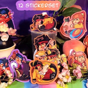 May include: A set of 12 colorful stickers featuring cartoon characters with different expressions. The stickers are arranged on a table with fruit and flowers. The text "12 STICKERSET" is visible at the top of the image.