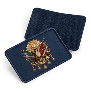 Könnte beinhalten: Ein blauer Stoff-Patch mit einem goldenen gestickten Design des türkischen Wappens. Das Design zeigt einen Halbmond, einen Stern und ein Schwert.