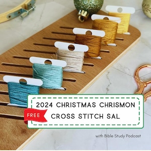 May include: A wooden cross stitch organiser with slots for storing embroidery floss. The organiser is filled with different colours of floss, including teal, light blue, beige, brown, and yellow. The text "2024 CHRISTMAS CHRISMON CROSS STITCH SAL FREE" is on a green and white label. The text "with Bible Study Podcast" is below the label.