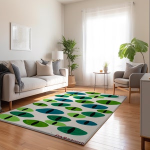 May include: A white rug with a repeating pattern of green, blue, and black eyes. The text "STICK TO" and "PARANOID" are printed on the rug.