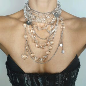 Glam rock statement necklace with quartz beads and 12 layered rows of silver-tone chains for editorial styling.
​