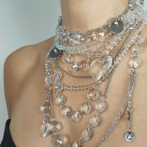 High-volume quartz jewelry hardware showing tarnish-free steel chains and natural clear quartz bead construction.
​