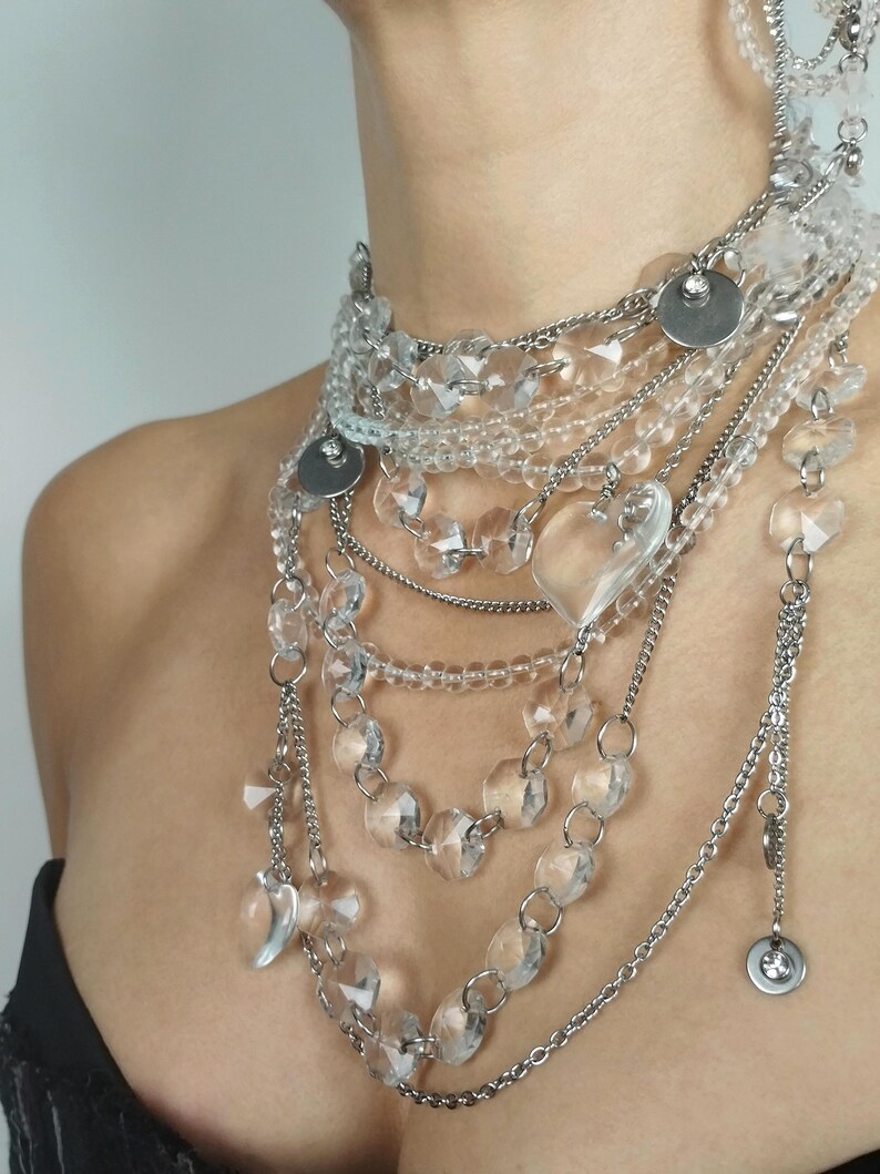 High-volume quartz jewelry hardware showing tarnish-free steel chains and natural clear quartz bead construction.
​