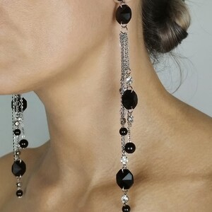 May include: Long black and silver dangle earrings with multiple black faceted beads and silver chains.