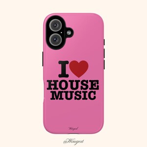 May include: Pink phone case with the text "I ❤️ HOUSE MUSIC" in black and red. The case has a camera cutout and black side buttons. The bottom of the case has the word "Winged" and the @Winged social media handle.