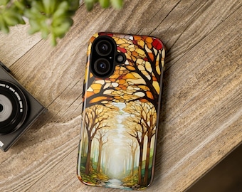 May include: A phone case featuring a colorful illustration of a forest scene with trees and a path. The design has warm tones of orange, yellow, and brown, with a touch of green. The case is on a wooden surface.