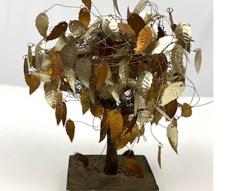 May include: A small wire sculpture of a tree with gold and silver leaves. The tree is on a square base.