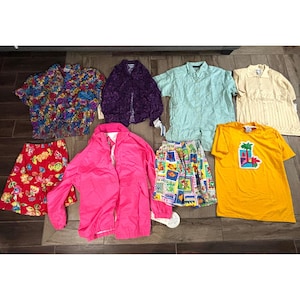 May include: A collection of vintage clothing items, including a floral print blouse, a purple jacket, a light blue button-down shirt, a yellow shirt with a palm tree graphic, and a pink jacket. Also included are a red floral skirt and a patterned skirt.