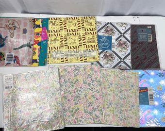 May include: An assortment of wrapping paper featuring various patterns and designs. The papers include a floral pattern, a geometric pattern, a pattern with the word "DAD" repeated, and a pattern with a cartoon character. The papers are all in different colours, including pink, blue, green, yellow, and brown.